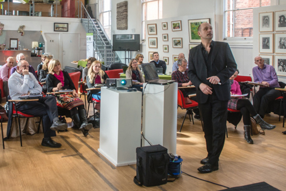 director andrew knutt delivering a business workshop in an arts centre